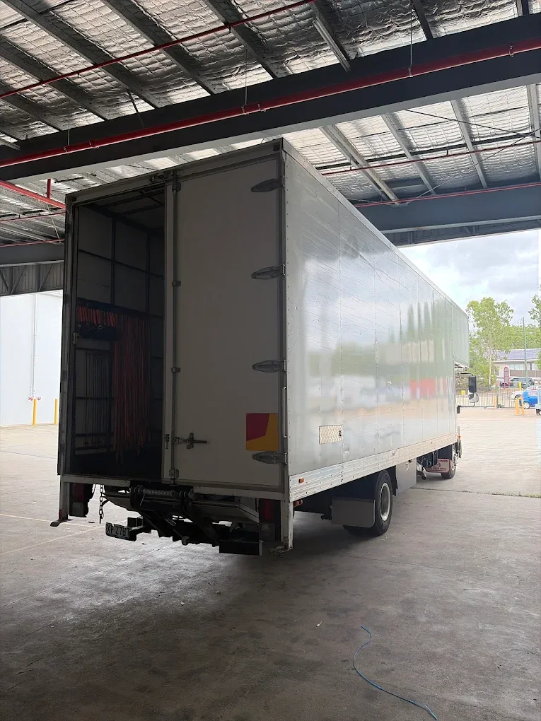 Royal Sydney Removals truck parked in the depot with its tail lift lowered and moving blankets stowed inside